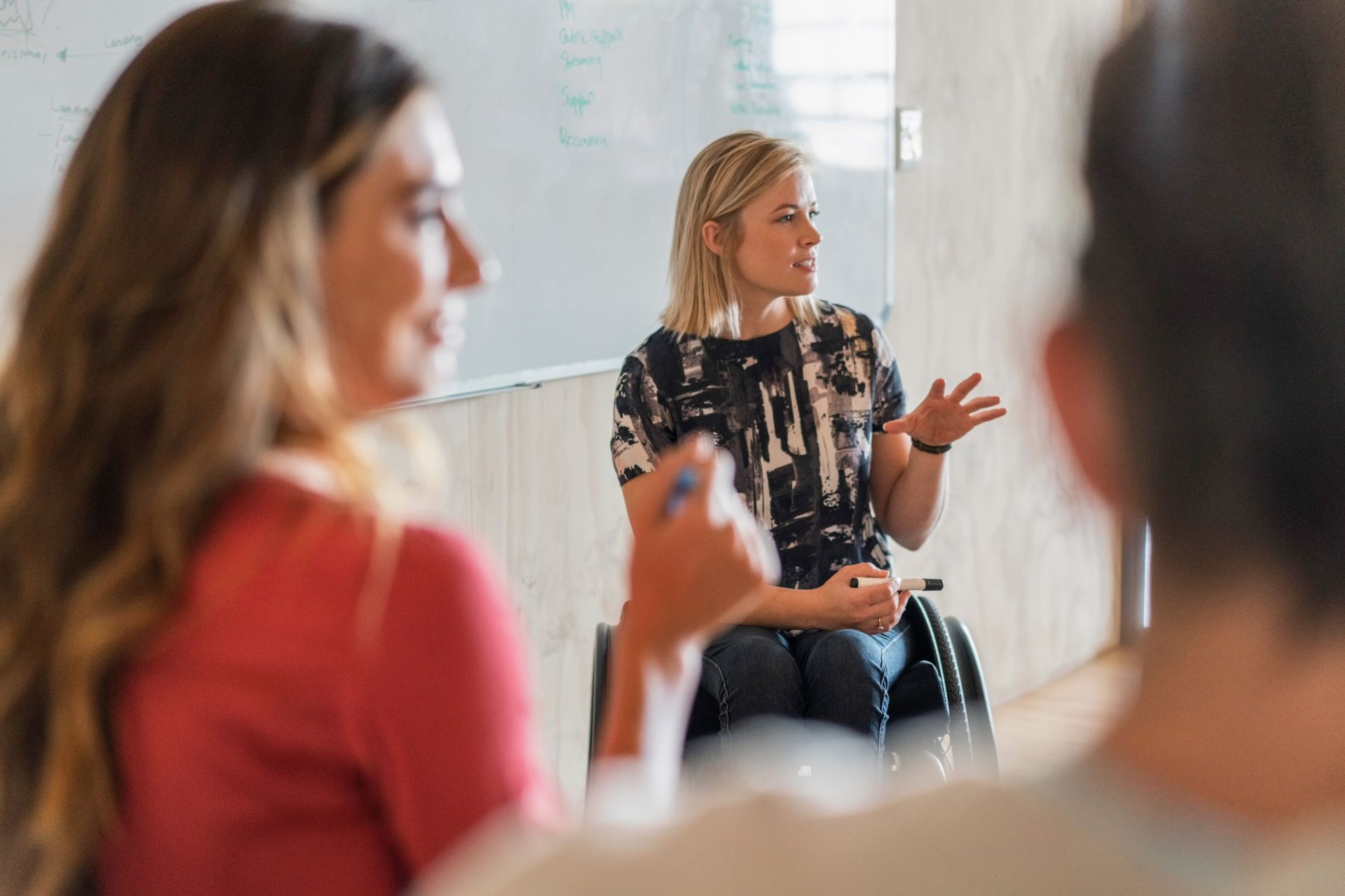 Disabled manager explaining strategy in office